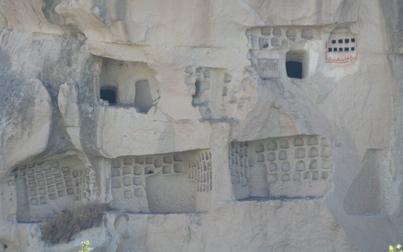 rock-cut dwellings in a cliff