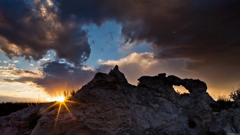 Rock Formation at Sunset — Blue, Dramatic, Photograph, Sun, Clouds, Grass