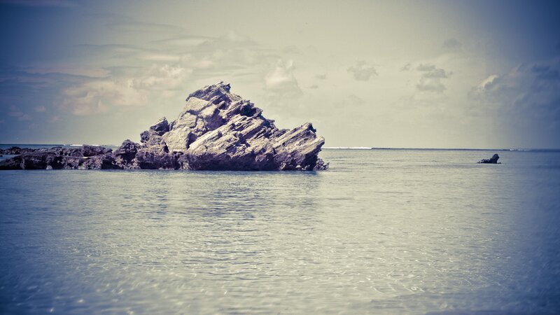 Rock formation in calm sea
