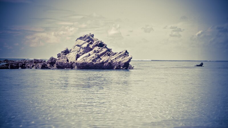 Rock formation in calm sea