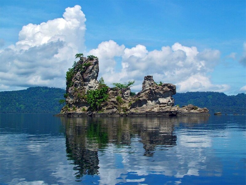 Rock formation in calm water