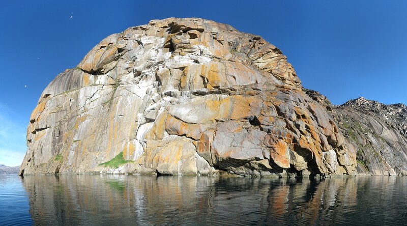 Rock formation in calm water