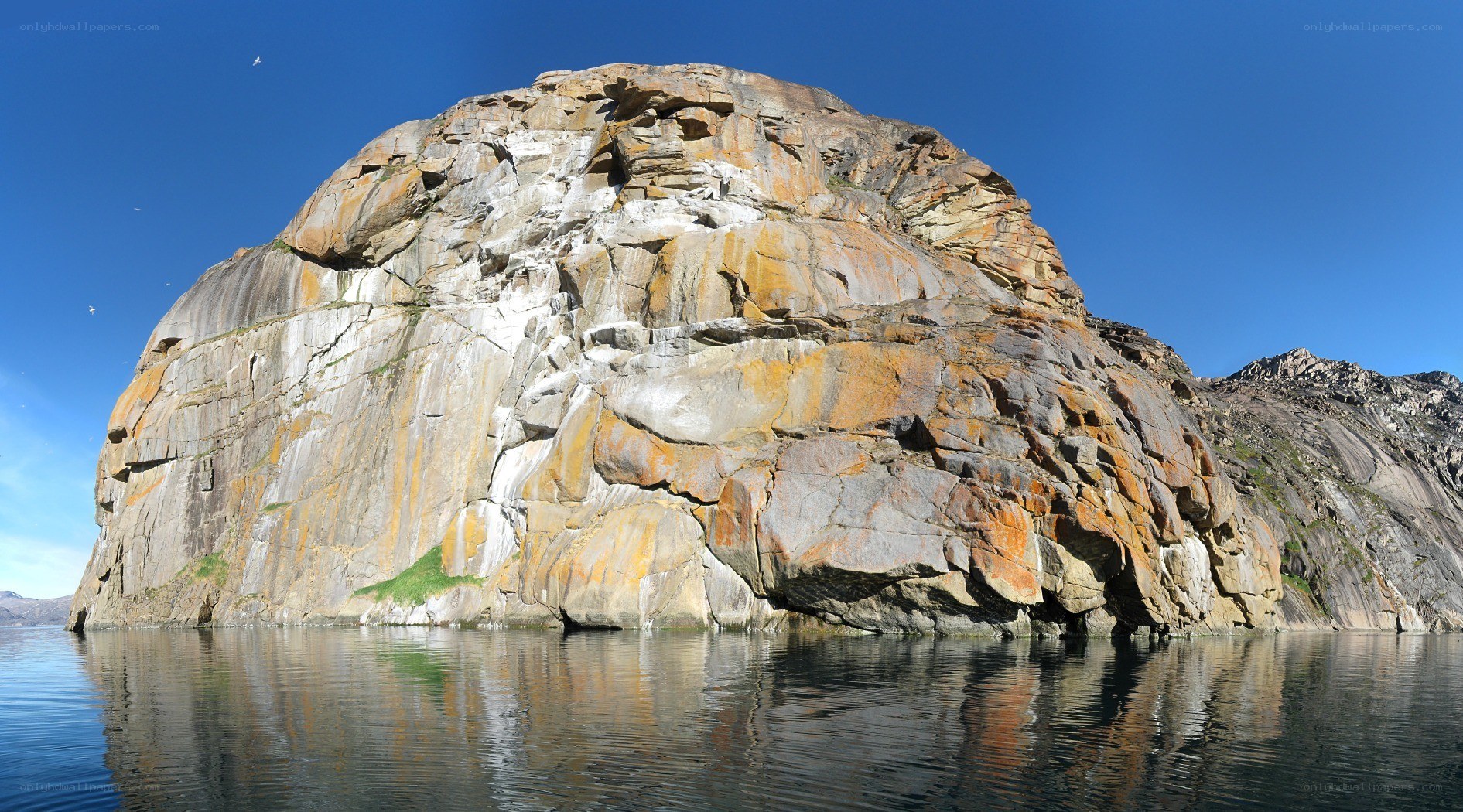 Rock formation in calm water