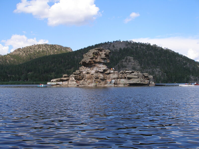 Rock formation in lake with boats