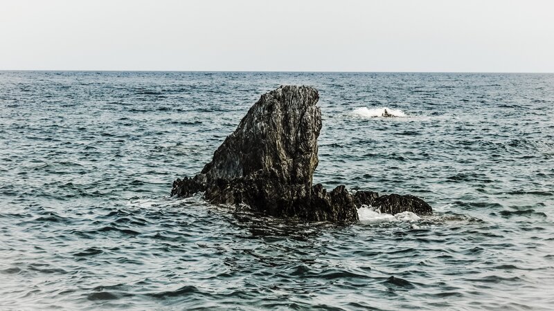 Rock Formation in Ocean — Blue, Calm, Photograph