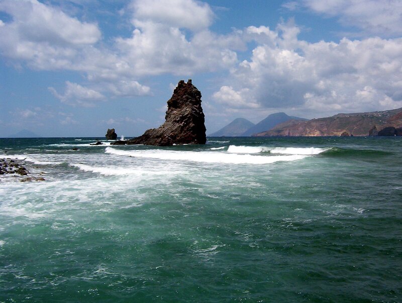 Rock Formation in Ocean — Blue, Dramatic, Afternoon, Photograph, Mountains