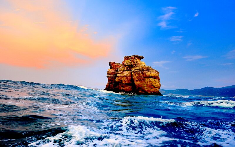 Rock Formation in Ocean — Blue, Dramatic, Sunset, Photograph, Sky, Mountains