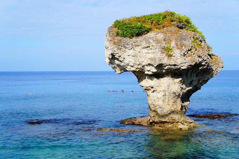 Rock Formation in Ocean — Blue, Serene, Afternoon, Photograph, Sky