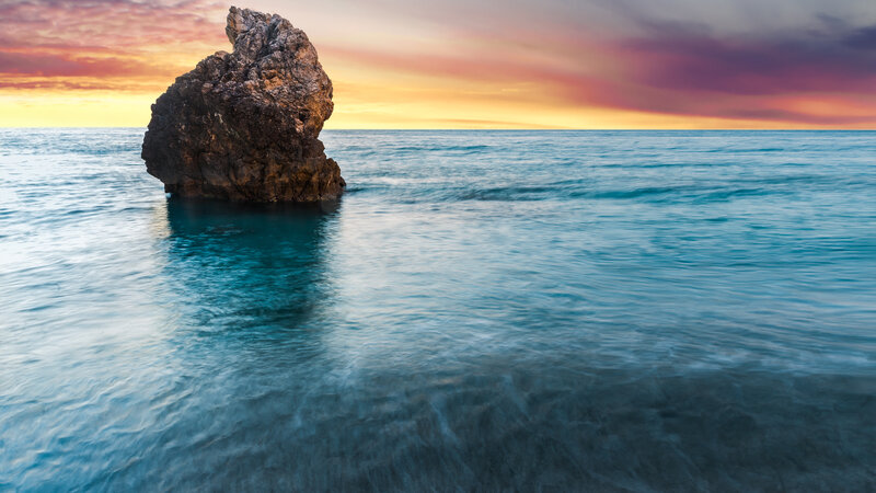 Rock Formation in Ocean — Blue, Serene, Sunset, Photograph, Sky, Clouds