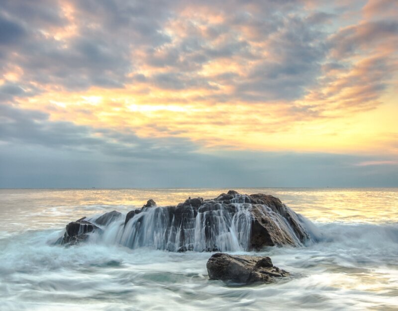Rock Formation in Ocean — Yellow, Serene