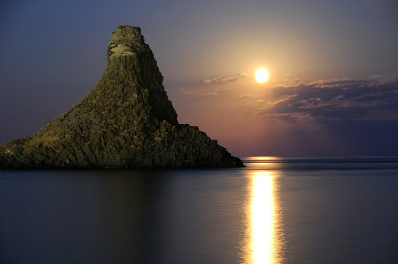 Rock Formation in Sea — Blue, Serene, Sunset, Photograph, Sun, Sky