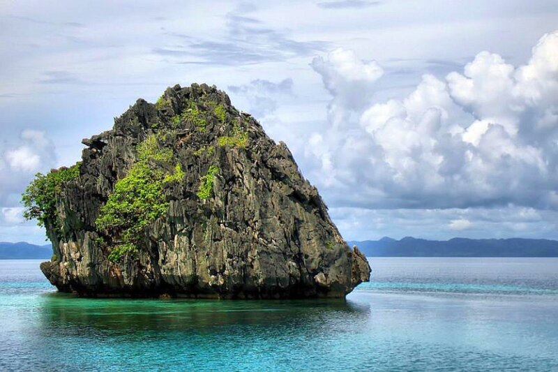 Rock formation in turquoise water