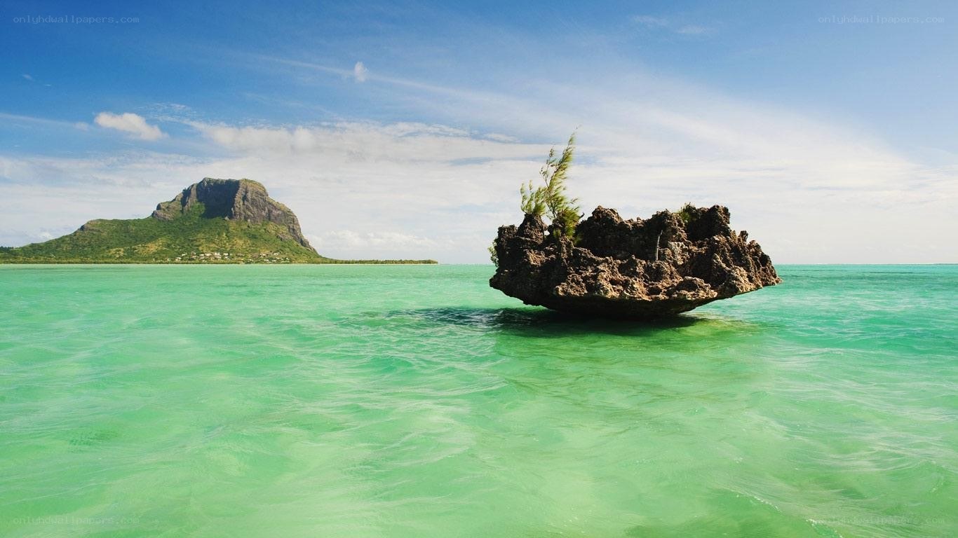 Rock formation in turquoise water