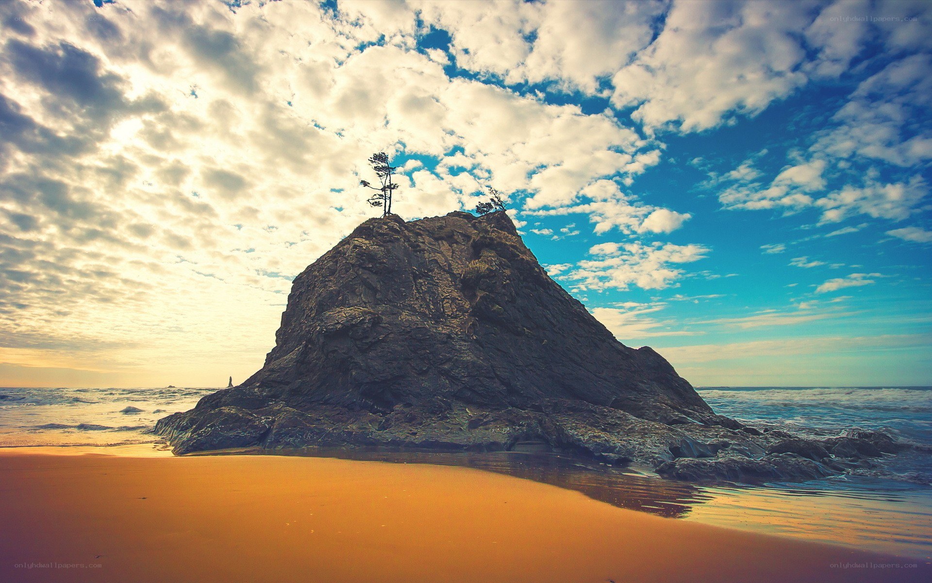 Rock formation on beach at sunset