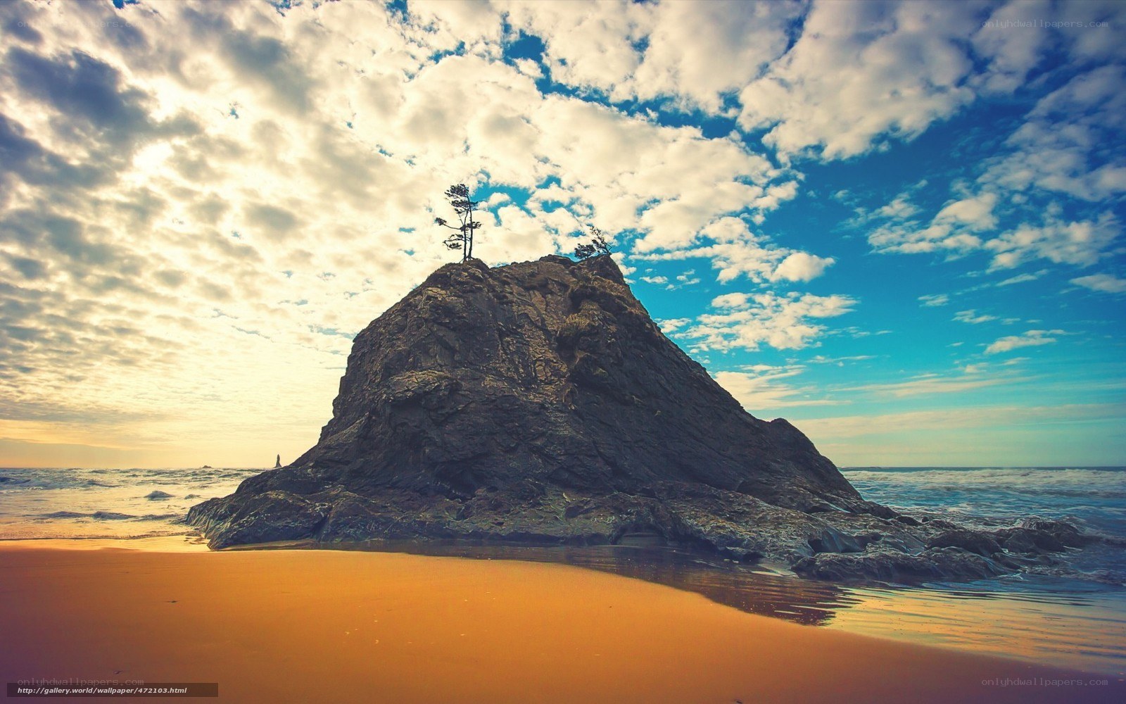 Rock formation on beach at sunset