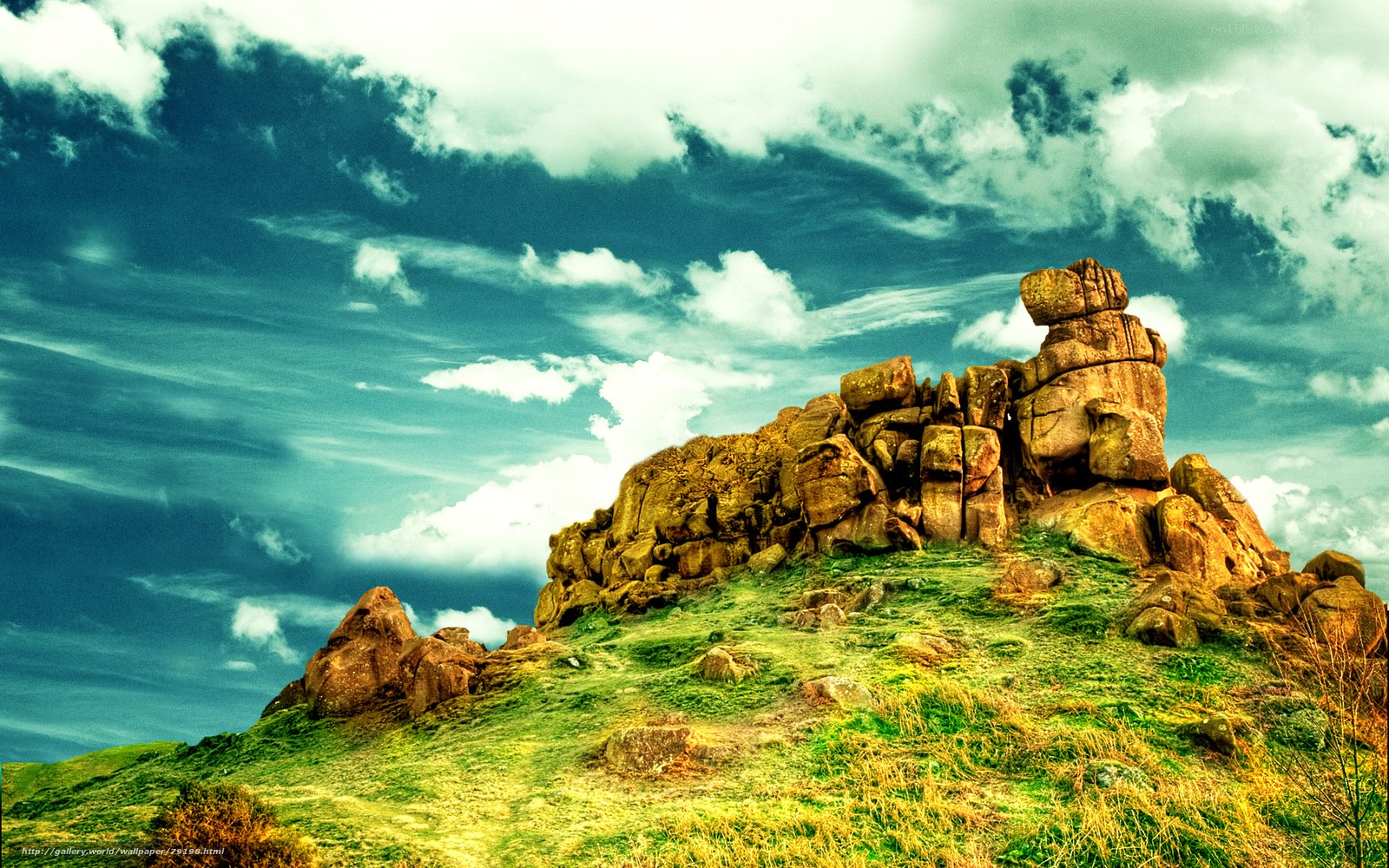 Rock formation on grassy hill