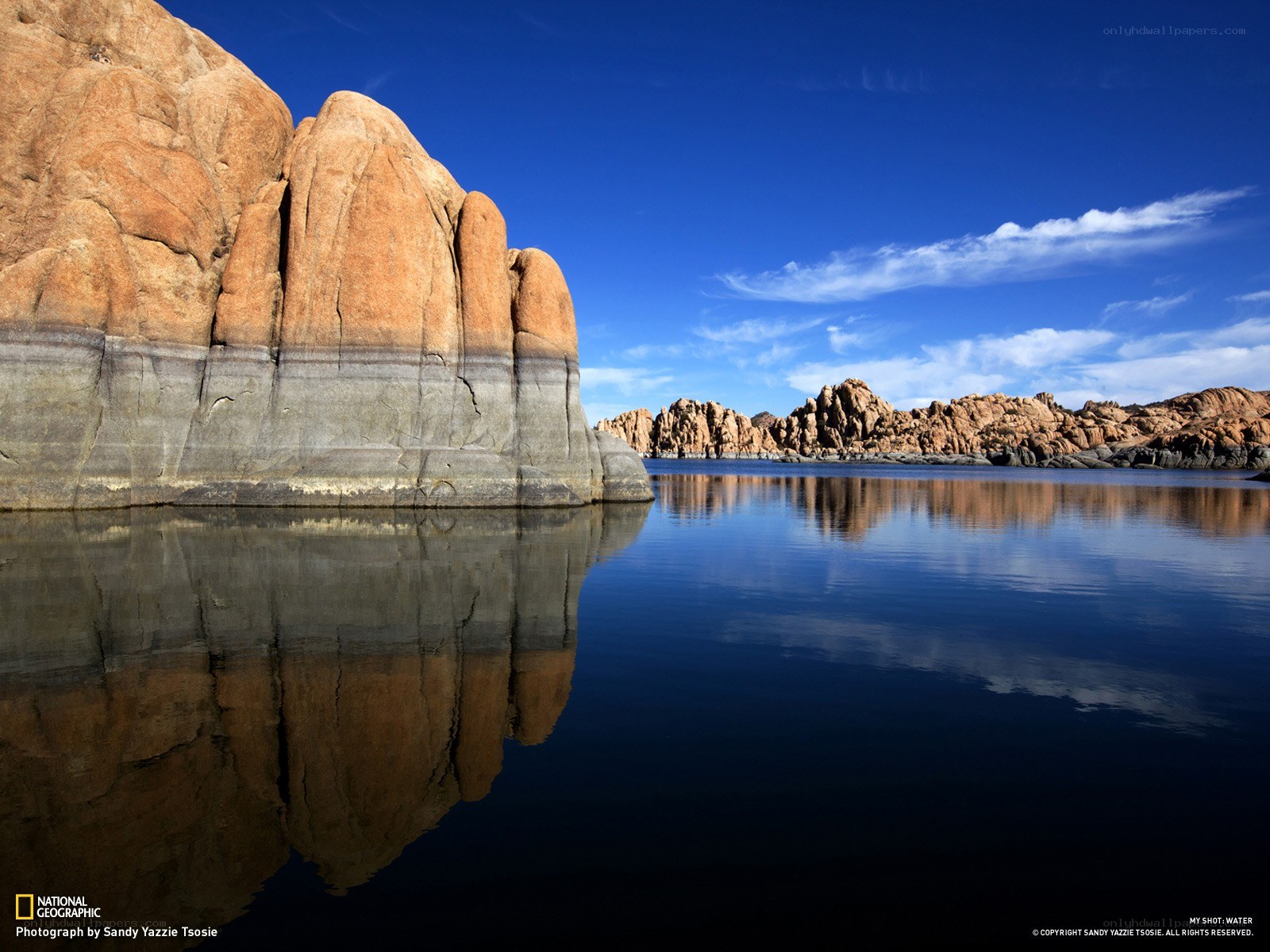 Rock formation reflected in calm water