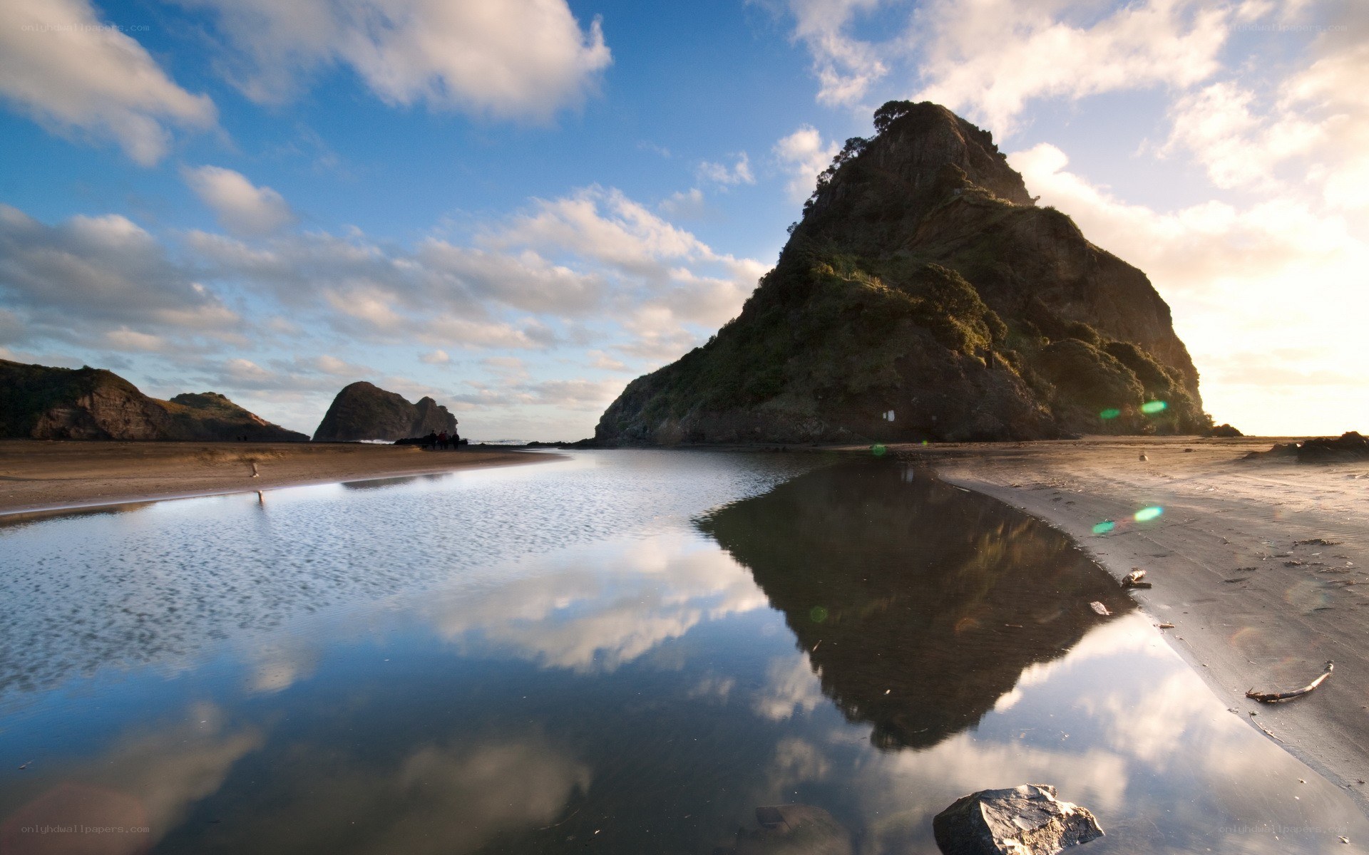 Rock formation reflected in tide pool