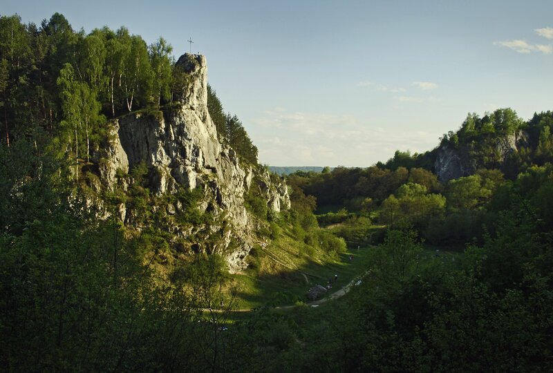 Rock formation with cross in forest