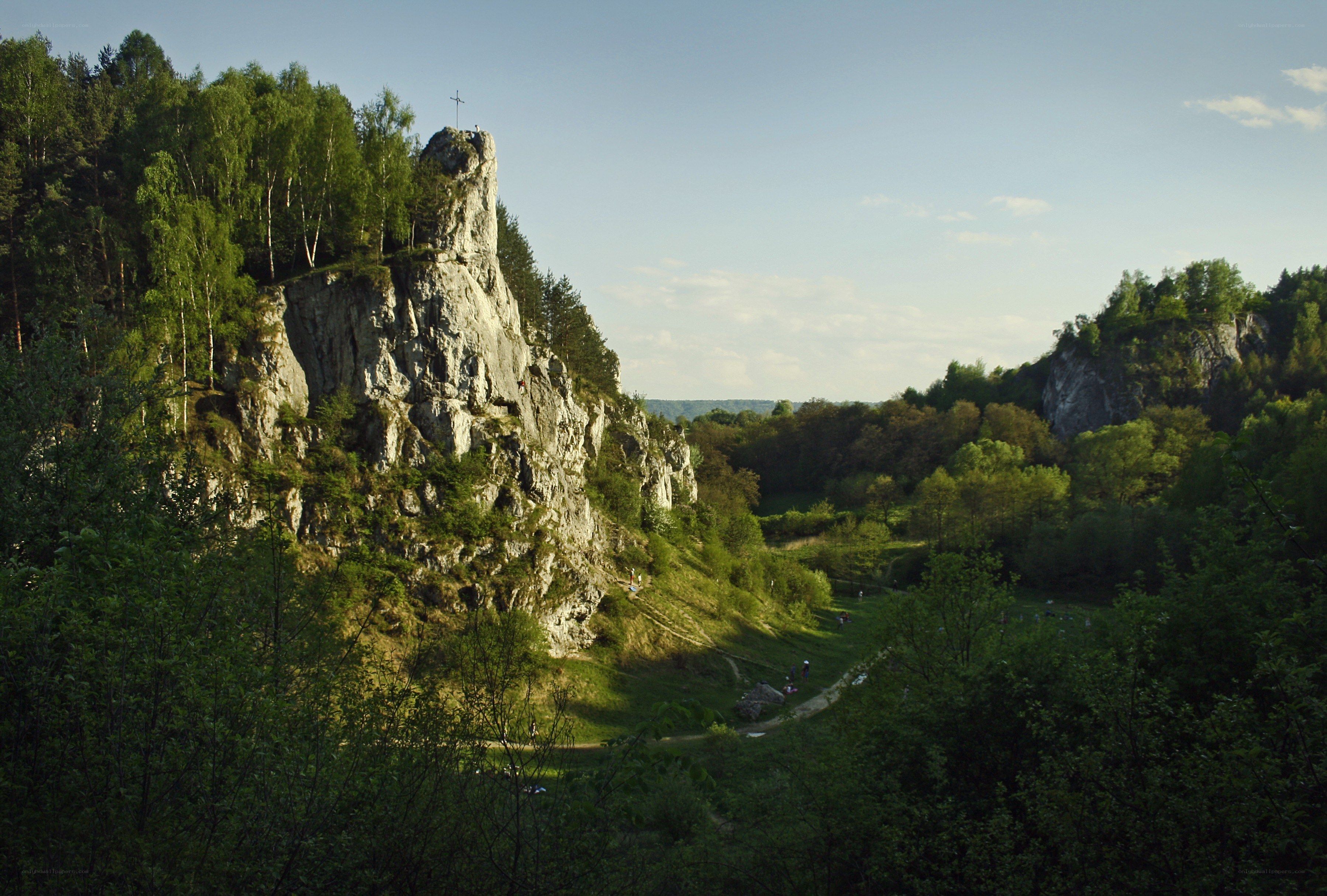 Rock formation with cross in forest