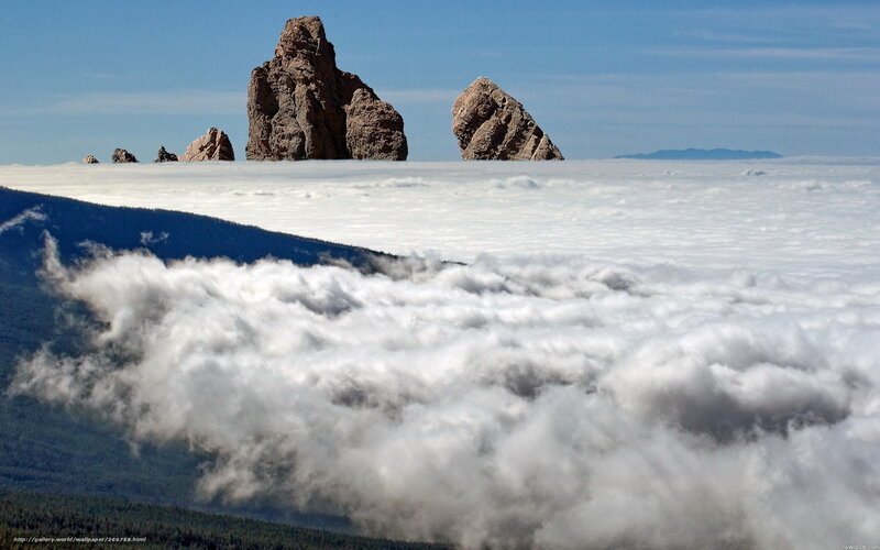 Rock formations above clouds