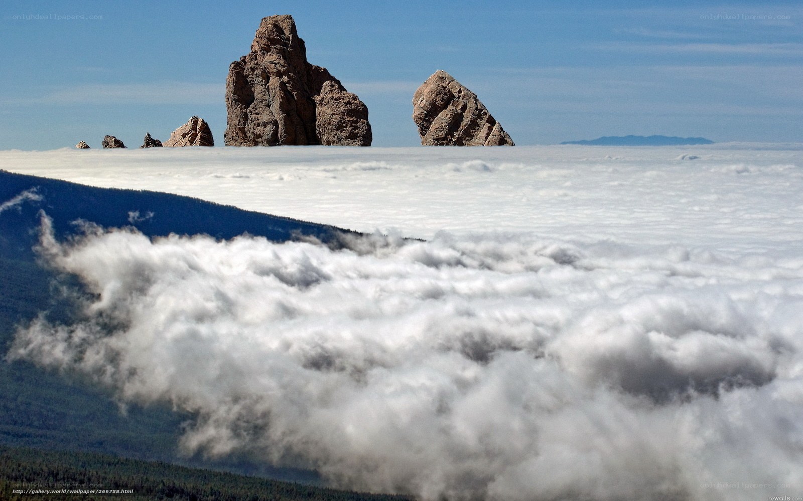 Rock formations above clouds