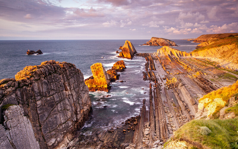 Rock Formations at Coast — Purple, Dramatic