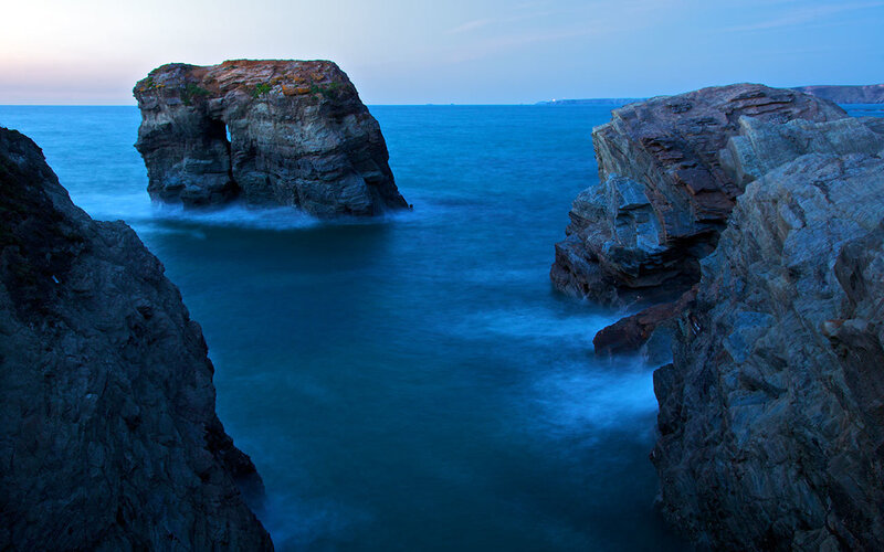 Rock formations at coastal inlet