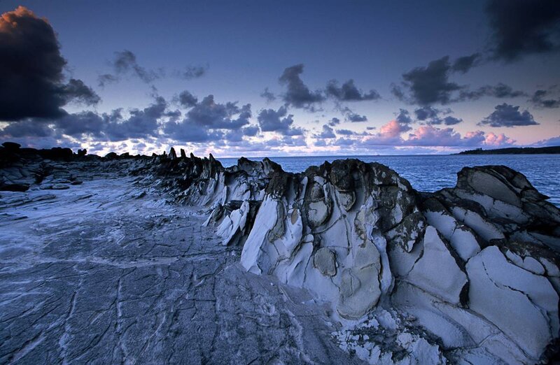 Rock formations at dusk by the sea