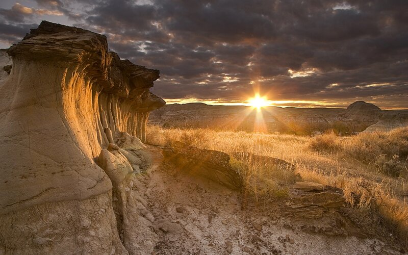 Rock Formations at Sunset — Brown, Dramatic, Photograph, Sun, Clouds, Grass