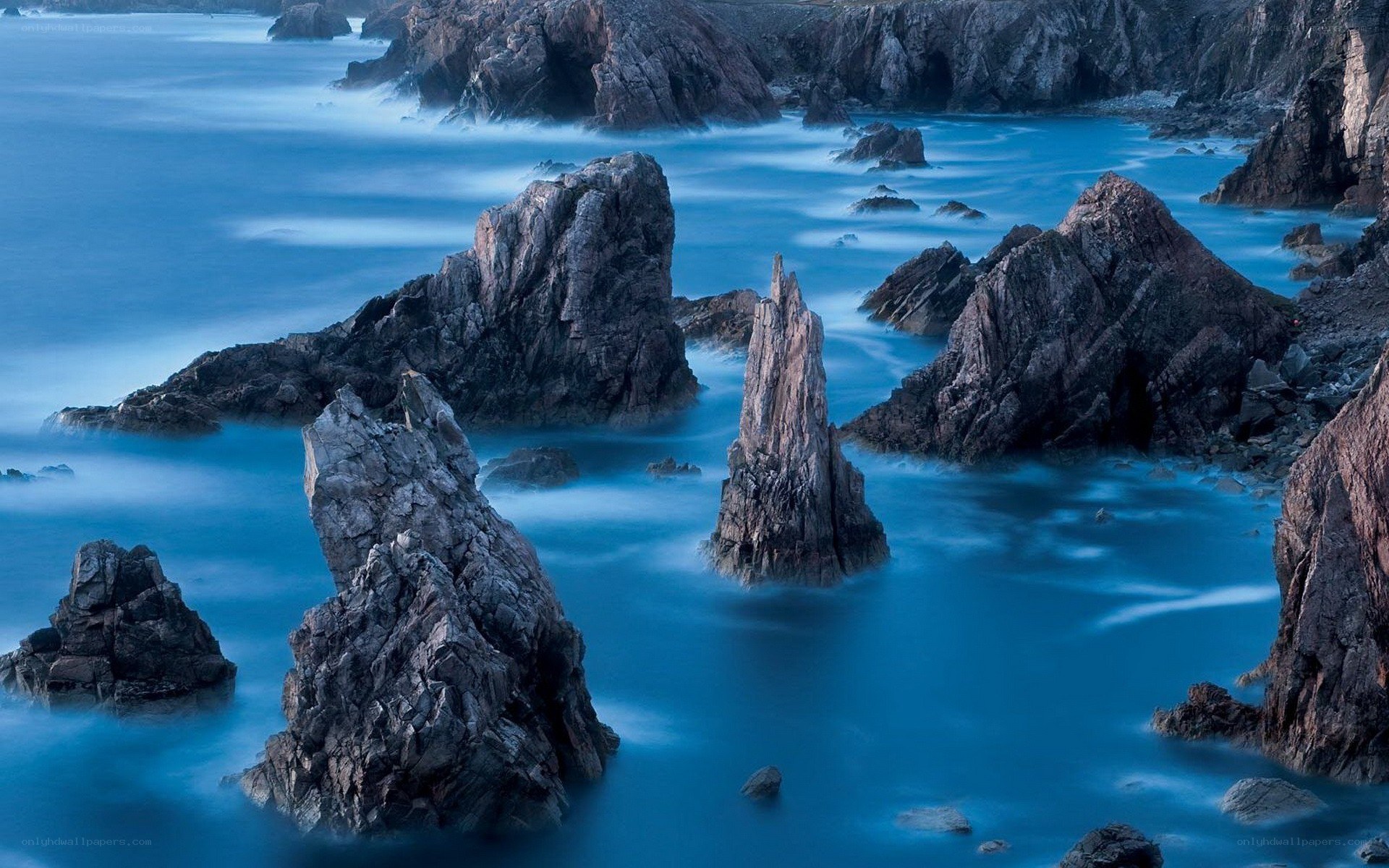 Rock formations in blue water