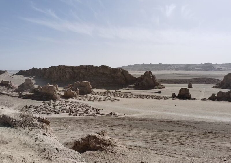 Rock Formations in Desert — Brown, Arid, Afternoon, Photograph, Sand, Sky, Mountains