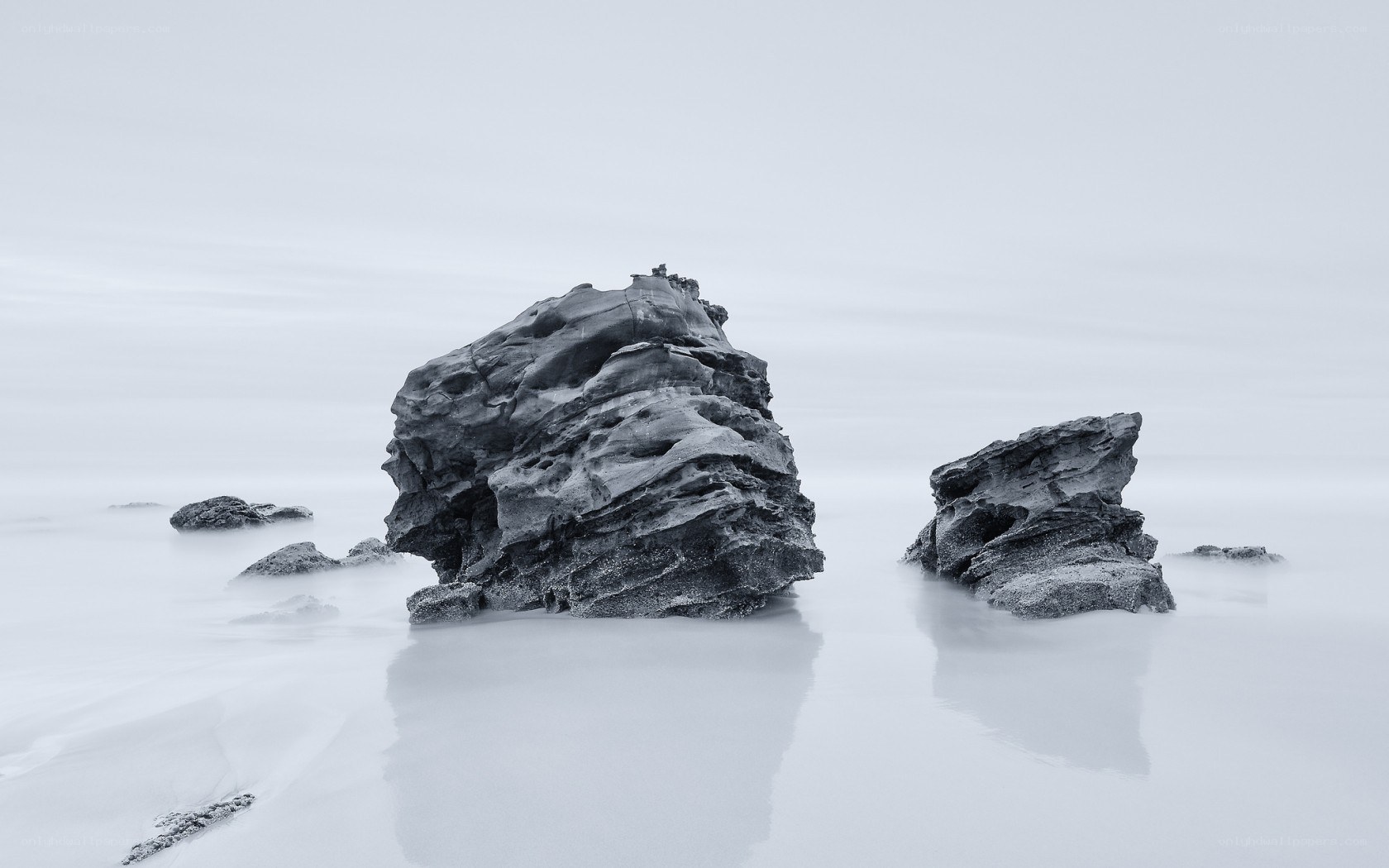 Rock formations in misty water