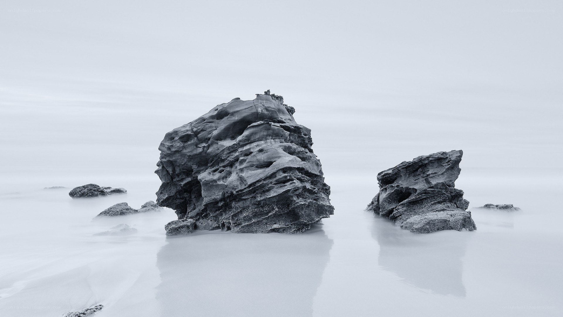 Rock formations in misty water