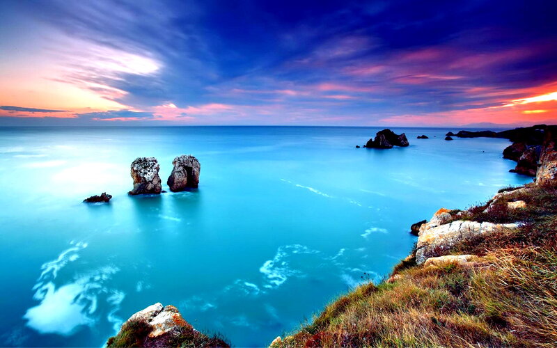 Rock Formations in Ocean — Blue, Dramatic, Sunset, Photograph, Sky, Rocks, Grass