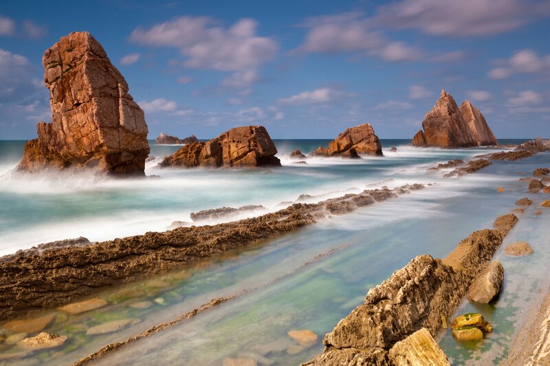 Rock Formations in Ocean — Blue, Serene, Afternoon, Photograph, Sky, Rocks, Brown, White