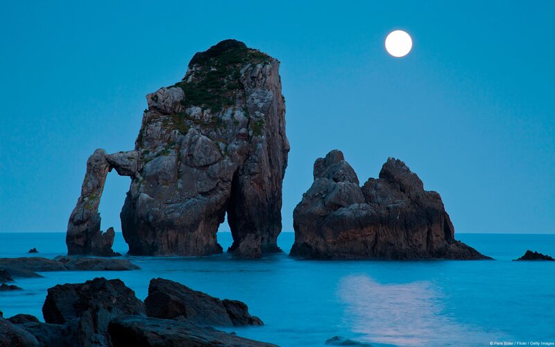 Rock Formations in Ocean — Blue, Serene, Night, Photograph, Moon, Sea, Sky