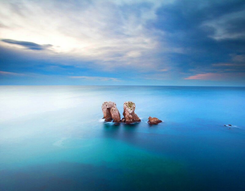 Rock Formations in Ocean — Blue, Serene, Sunset, Photograph, Sky, Clouds