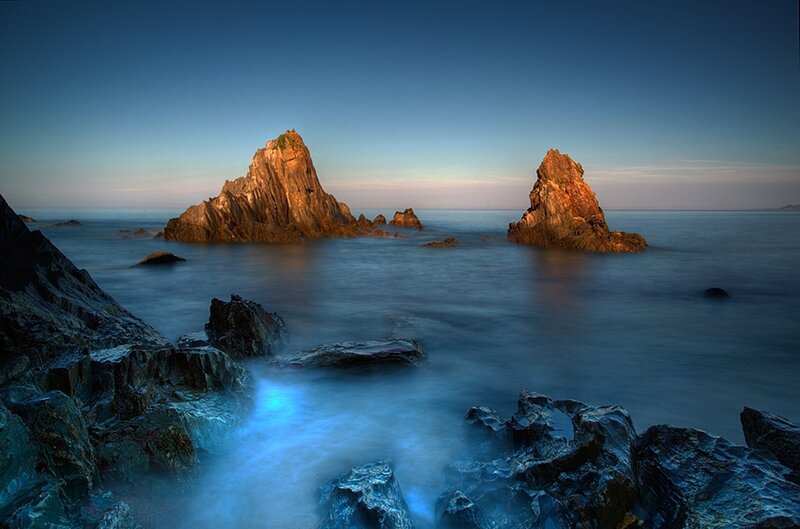 Rock Formations in Ocean — Blue, Serene, Sunset, Photograph, Sky, Rocks, Brown