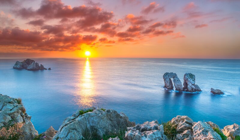 Rock Formations in Ocean — Blue, Serene, Sunset, Photograph, Sun, Sea
