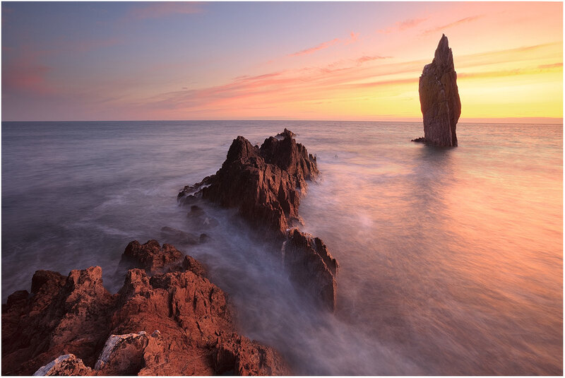 Rock Formations in Ocean — Orange, Serene
