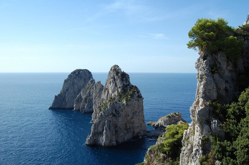 Rock Formations in Sea — Blue, Serene, Afternoon, Photograph, Cliffs, Trees, Gray