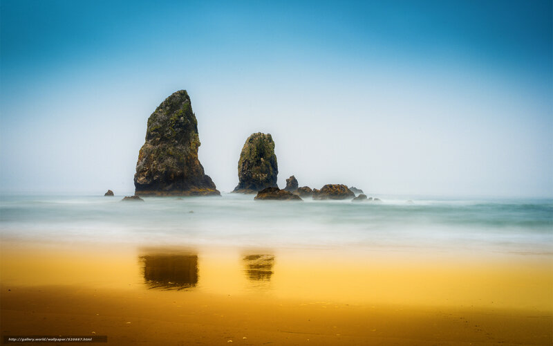 Rock formations on beach at sunset