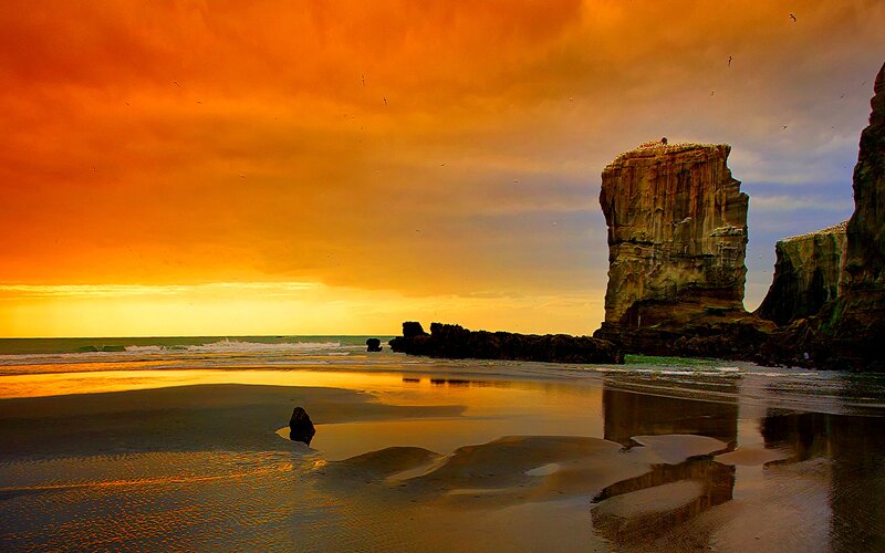 Rock Formations on Beach — Orange, Dramatic, Sunset, Photograph, Ocean, Sky