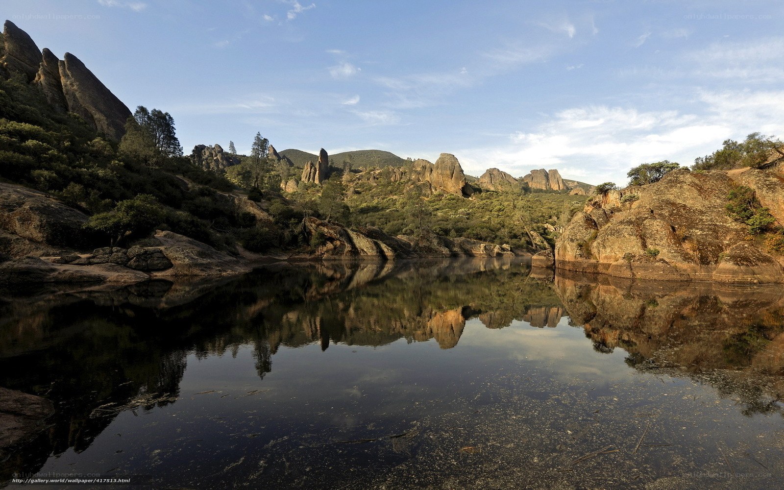 Rock formations reflected in calm water
