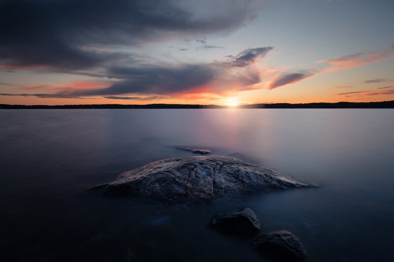 Rock in Calm Water — Orange, Serene, Sunset, Photograph, Sun