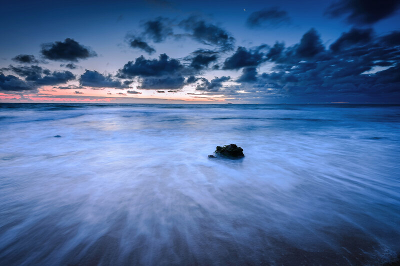 Rock in Ocean at Dusk
