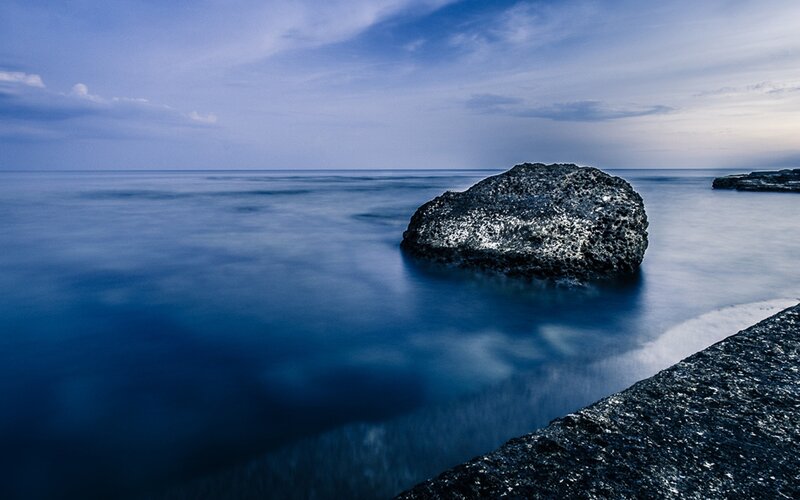 Rock in the ocean at dusk