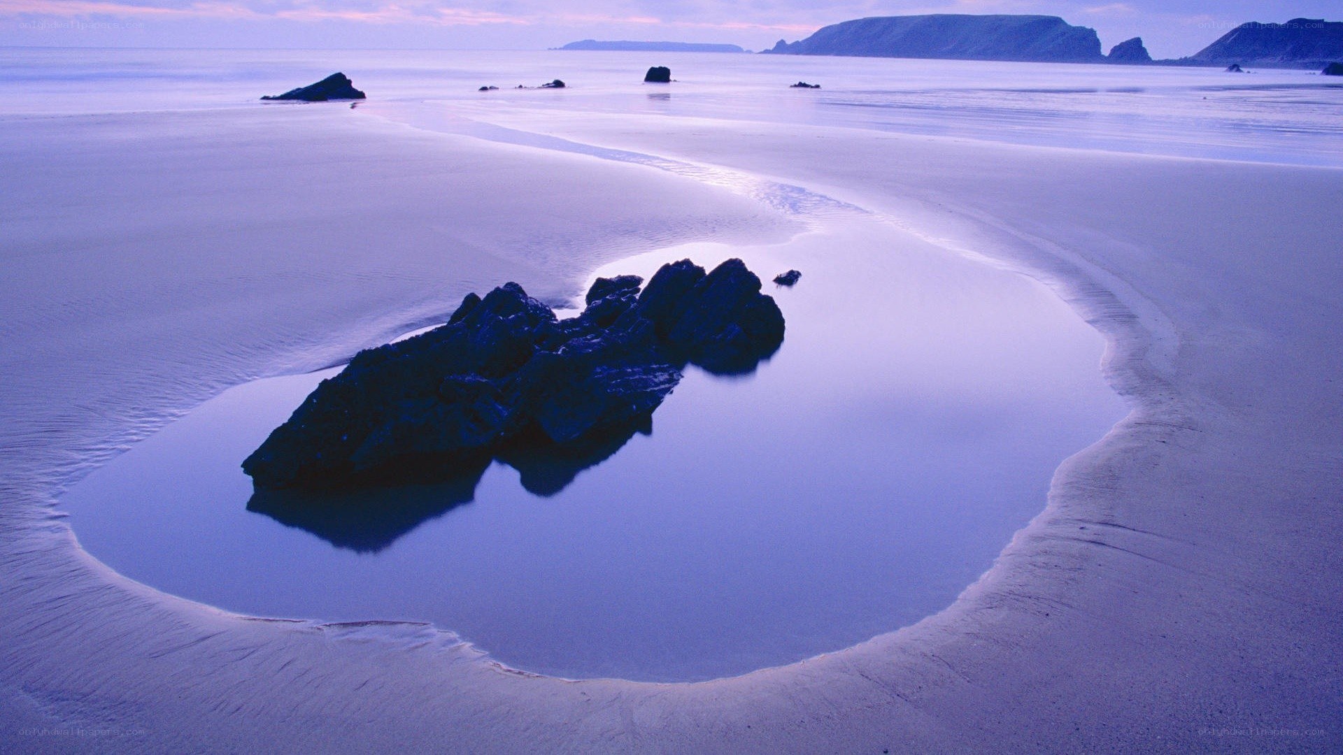 Rock in tidal pool at dusk
