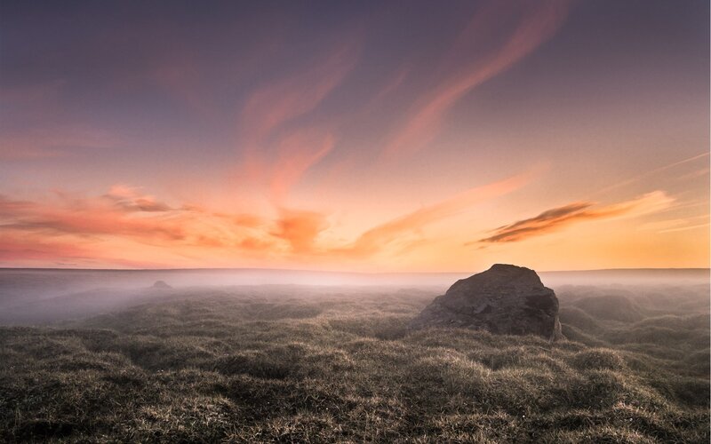Rock on Grassy Hill — Orange, Serene, Sunset